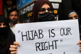A Muslim woman holds a placard as she takes part in a protest organised by All India Majlis-e-Ittehadul Muslimeen (AIMM) against the recent hijab ban in few colleges of Karnataka state, at Shaheen Bagh in New Delhi, India
