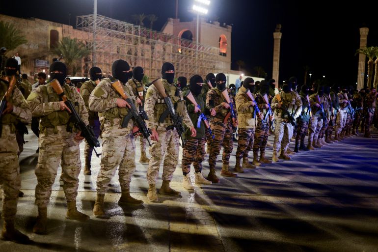Members of the military personnel arrive to take part in a parade calling for parliamentary and presidential election, at Martyr's square in Tripoli, Libya
