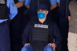 Former Honduras President Juan Orlando Hernandez wearing a life vest