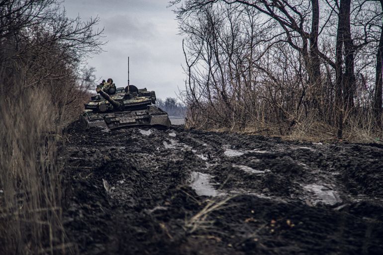 A service member of the Ukrainian Naval Infantry Corps (Marine Corps) rides a tank during drills at a training ground in an unknown location in Ukraine,