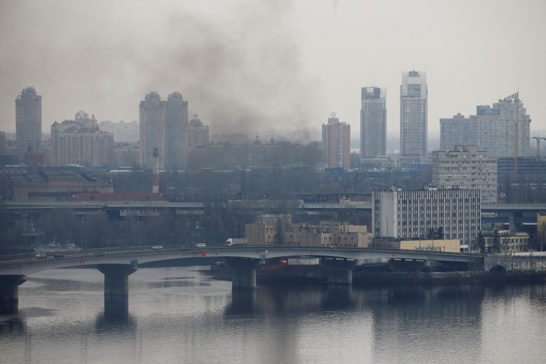 Smoke is seen rising from a building in Kyiv