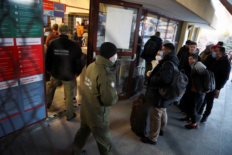 People line up at the customs clearance center after arriving by train from Ukraine, in Przemysl, Poland