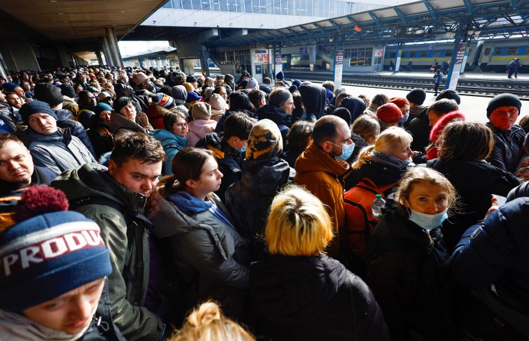 People wait to board a evacuation train from Kyiv to Lviv at Kyiv central train station, Ukraine, 