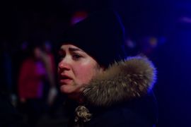 A Ukrainian woman reacts after crossing into Romania