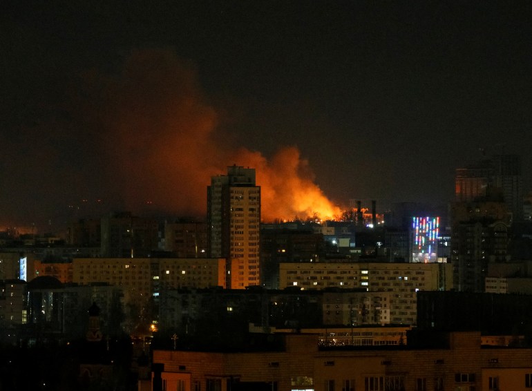 Smoke and flames rise in the night sky during the shelling near Kyiv.