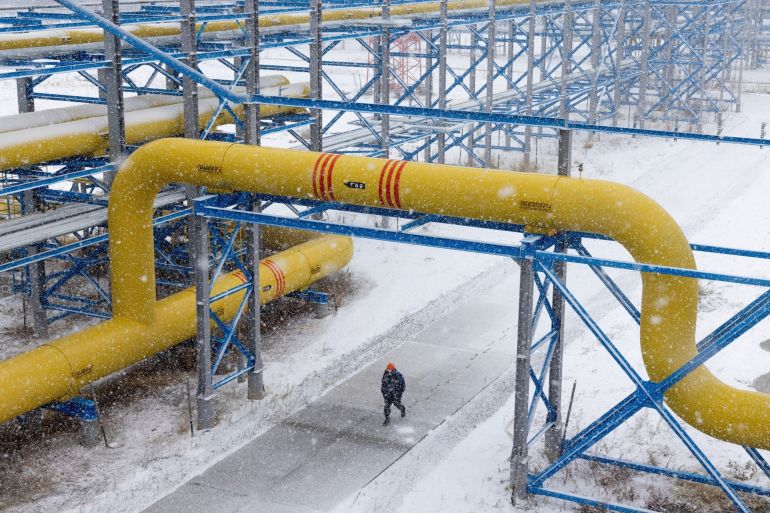 A worker walks under pipework in Lensk district of Sakha Republic, Russia