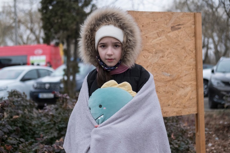 Sofia, 11 years old, from Chernivtsi, holds her favorite toy after arriving in Romania at Siret with her mother and brother.