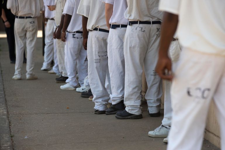 prisoners stand in a crowded lunch line during a prison tour at Elmore Correctional Facility in Elmore, Alabama