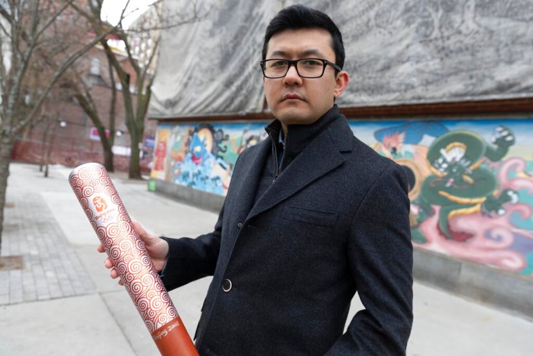 Kamaltürk Yalqun holds the aluminium Olympics torch he carried at the 2008 Beijing Olympic Games at the age of 17, on Friday, January 28, 2022, in Boston. The decade after the Games saw Beijing impose policies on his region of Xinjiang that split apart his family and Uighur community. Today, he is an activist in the United States calling for a boycott of the 2022 Winter Games, which will see the Olympic flame returned to Beijing