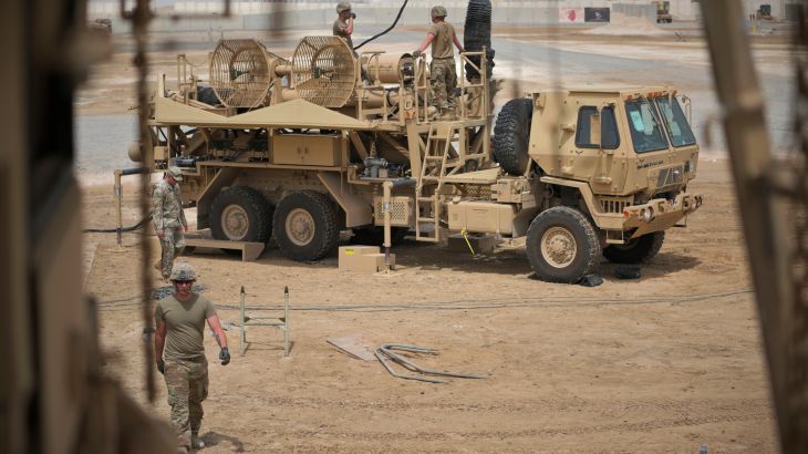 In this photo released by the U.S. Air Force, U.S. Army troops work near a Patriot missile battery at Al-Dhafra Air Base in Abu Dhabi