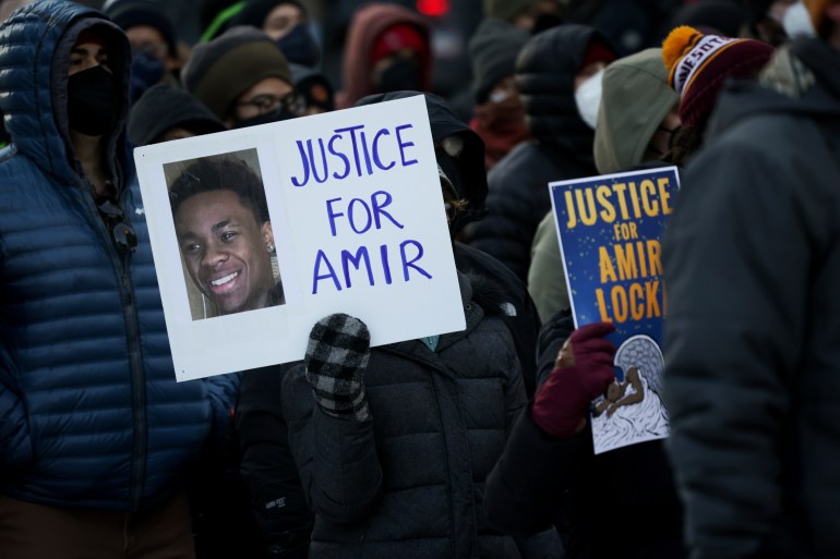 A protester holds a sign demanding justice for Amir Locke