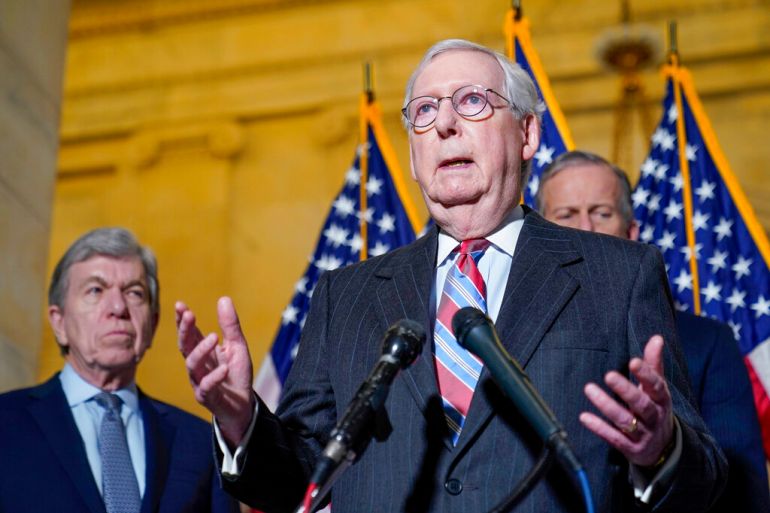 Senate Minority Leader Mitch McConnell of Ky., center, speaks to reporters on Capitol Hill in Washington, Tuesday, Feb. 8, 2022. Standing with McConnell is Sen. Roy Blunt, R-Mo., left, and Sen. John Thune, R-S.D., right.