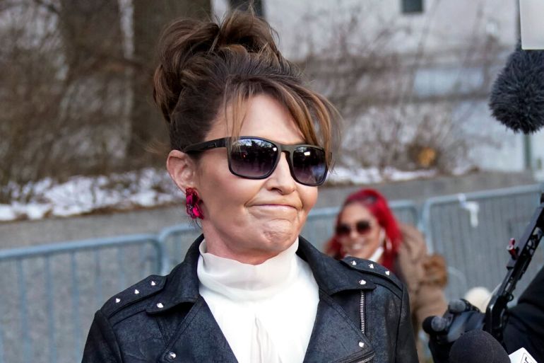 Former Alaska Gov. Sarah Palin reacts with a grimace as she leaves a courthouse in New York.