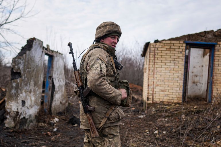 A Ukrainian serviceman stands at his position at the line of separation between Ukraine-held territory and rebel-held territory near Svitlodarsk, eastern Ukraine