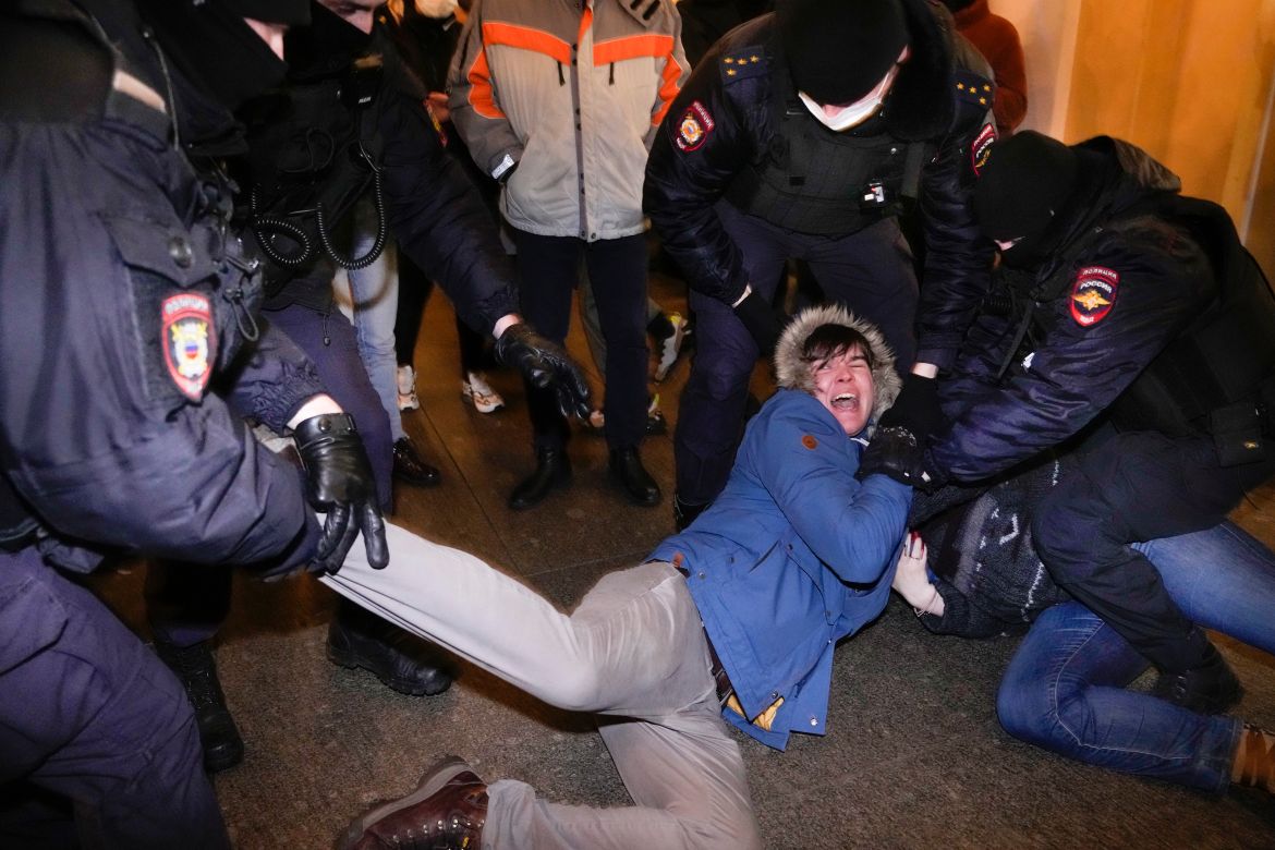 Police officers detain demonstrators in St. Petersburg