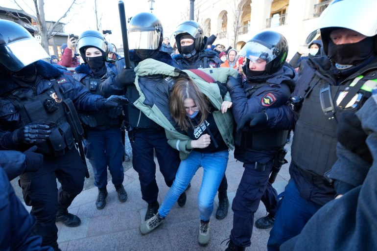 Police detain a demonstrator during an action against Russia's attack on Ukraine in St. Petersburg, Russia