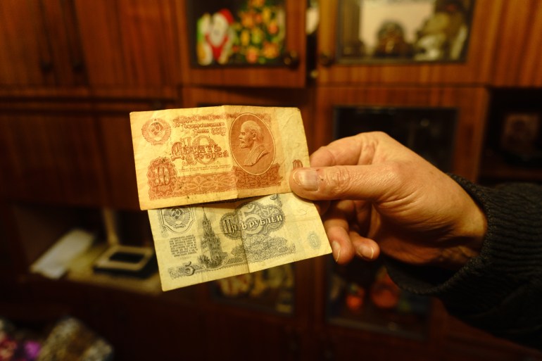 Valeriy Dzyubinskiy at his house showing his Soviet ruble money collection.Krasnohorivka