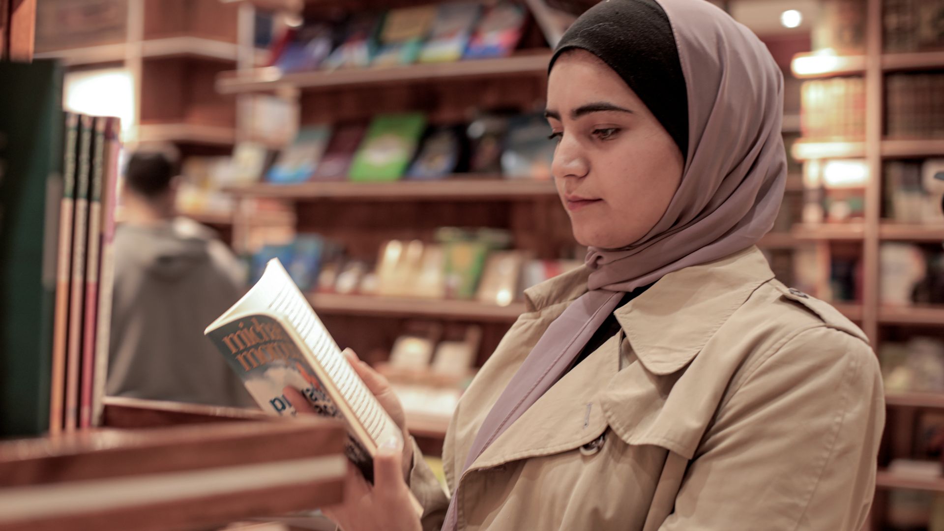 A young woman reads through a book