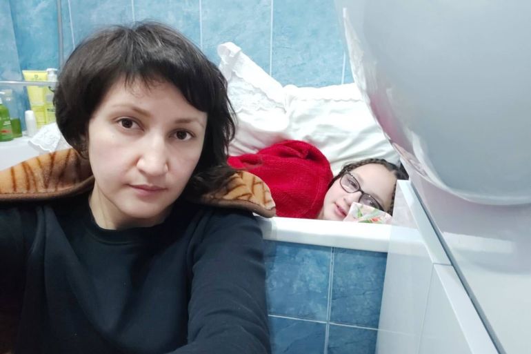 Since Saturday, Zakhida Adylova, a Ukrainian woman with short dark hair is seen sitting on the floor of her blue tiled bathroom while her 11-year-old daughter Samira lies in the bathtub