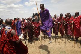 Maasai men prepare to greet Camilla, Duchess of Cornwall and Prince Charles, Prince of Walesas they visit Majengo Maasai Boma on November 9, 2011 in Arusha, Tanzania.