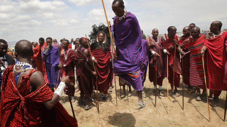 Maasai men prepare to greet Camilla, Duchess of Cornwall and Prince Charles, Prince of Walesas they visit Majengo Maasai Boma on November 9, 2011 in Arusha, Tanzania.
