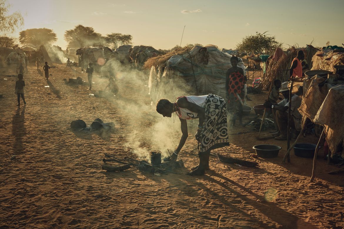 A photo of a woman cooking at the Etunda Refugee Camp.