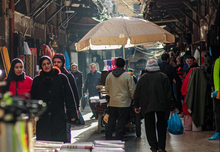 People walk through market in Tripoli, north Lebanon.