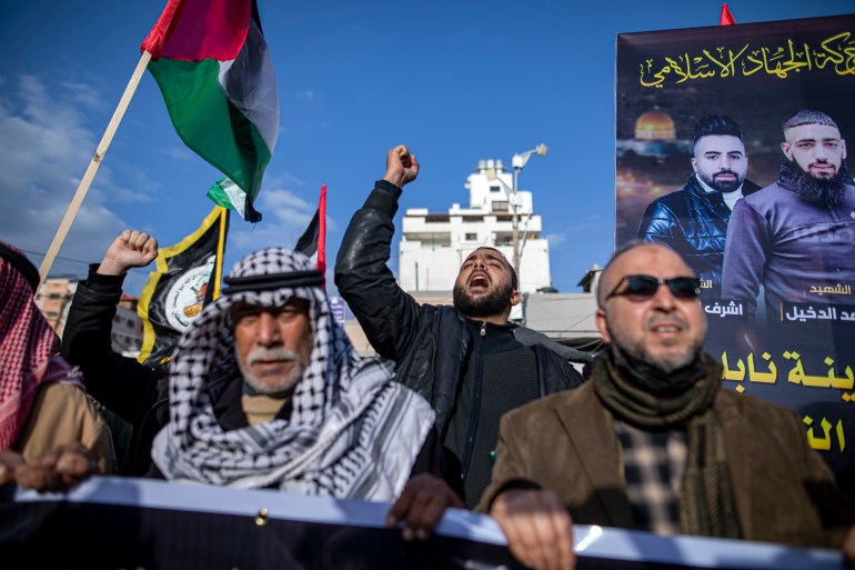 Palestinins chant slogans denouncing Israeli occupation.