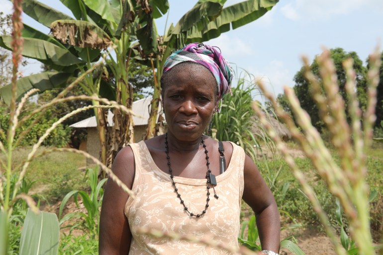 Mamie Achion, a female farmer in Sierra Leone, stands in a field