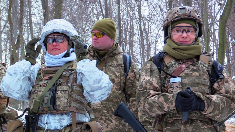 Mariana Zhaglo, left, and Marta Yuzhkiv, right, during their weekly territorial defense training in Kyiv, Ukraine [Mansur Mirovalev/Al Jazeera]