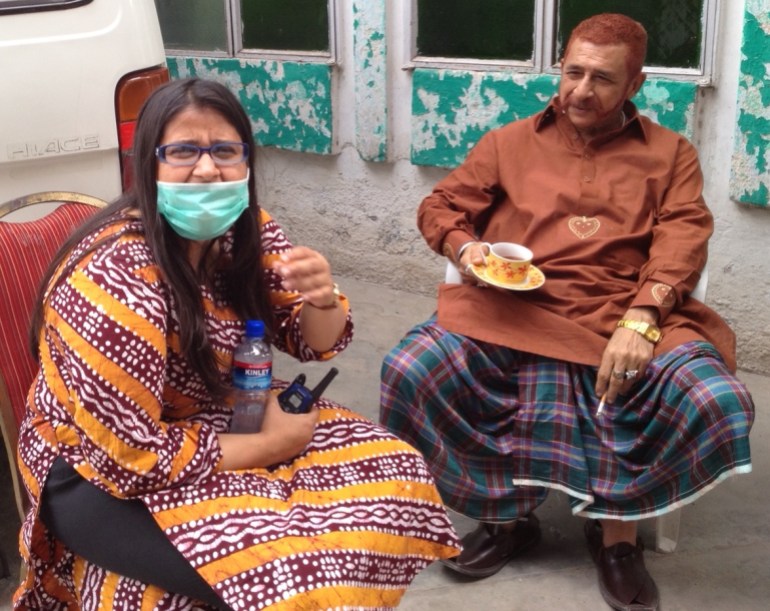 A photo of Meenu on the left wearing a mask and holding a bottle of water and a walkie talkie and a man holding a cup of tea on the right.