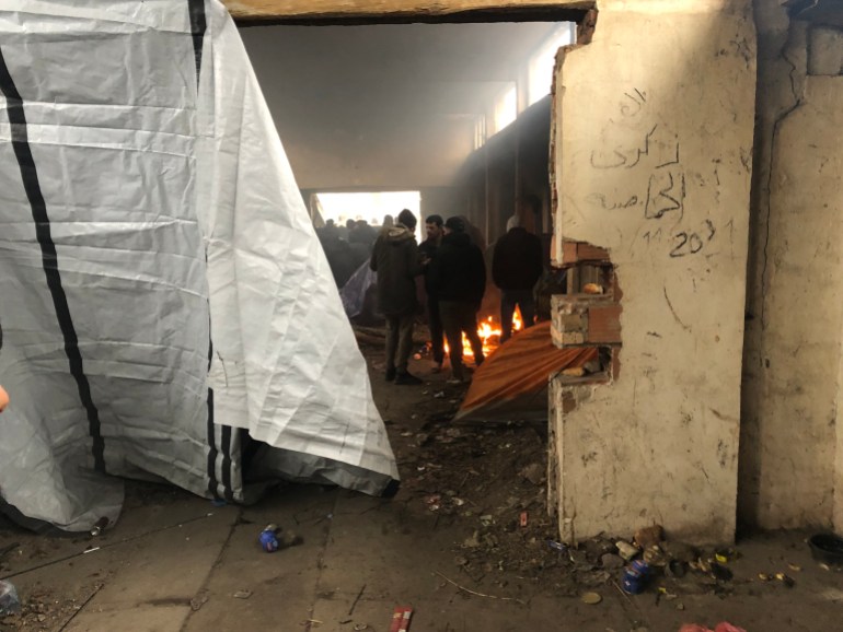 Asylum seekers trying to stay warm in an abandoned building