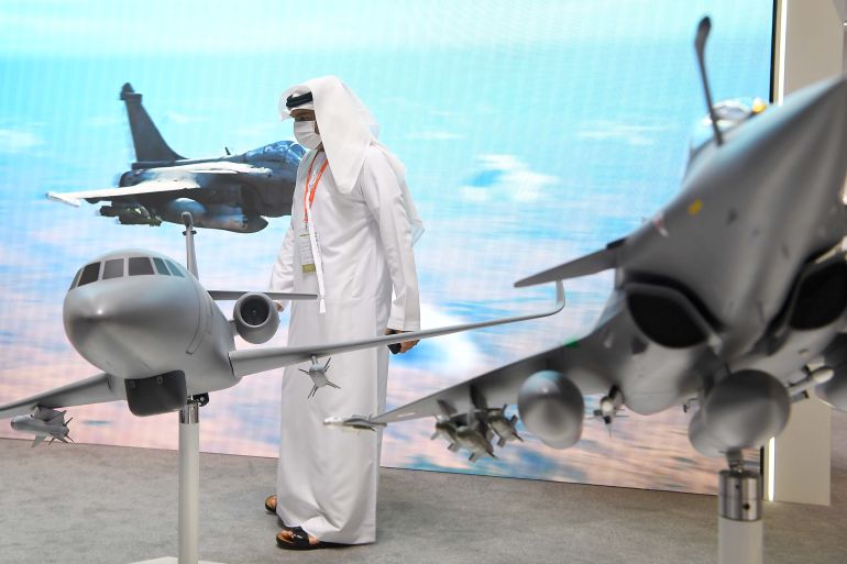 A man in Abu Dhabi stands at the International Defence Exhibition and Conference in February 2021