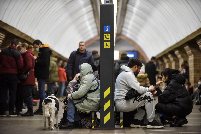 Ukrainians take shelter in a metro station after air raid sirens alarm in Kiev