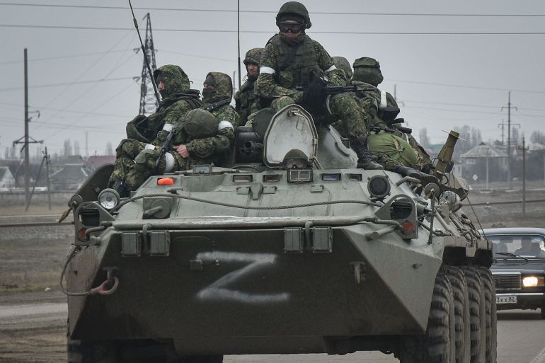Russian soldiers on an armoured personnel carrier move towards mainland Ukraine on the road near Armiansk, Crimea.