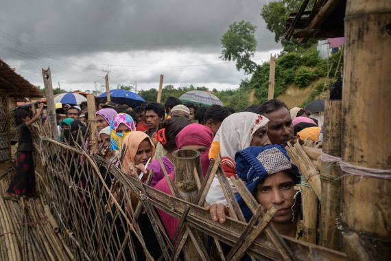 Rohingya refugees queue at an aid relief distribution centre at the Balukhali refugee camp near Cox's Bazar