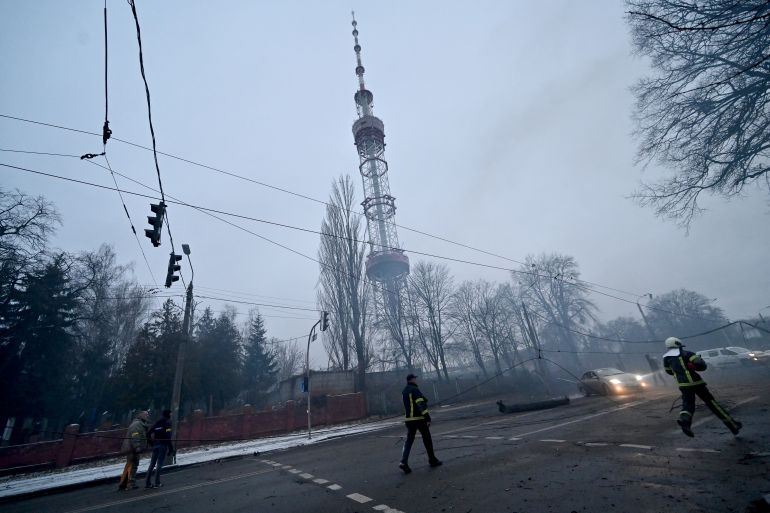 A fireman runs after Russian airstrike hit Kyiv's main television tower in Kyiv