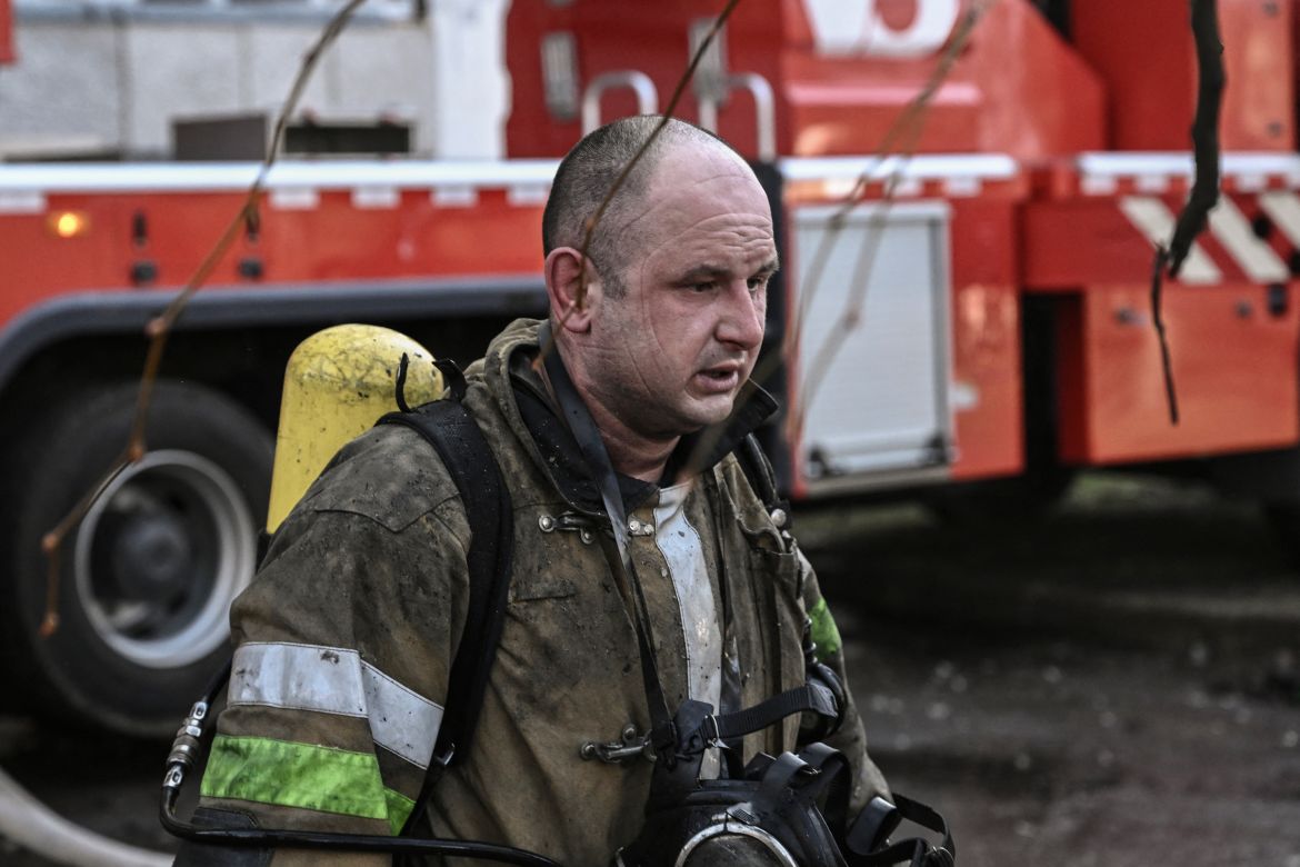 A fireman reacts outside a burning apartment building in Kyiv