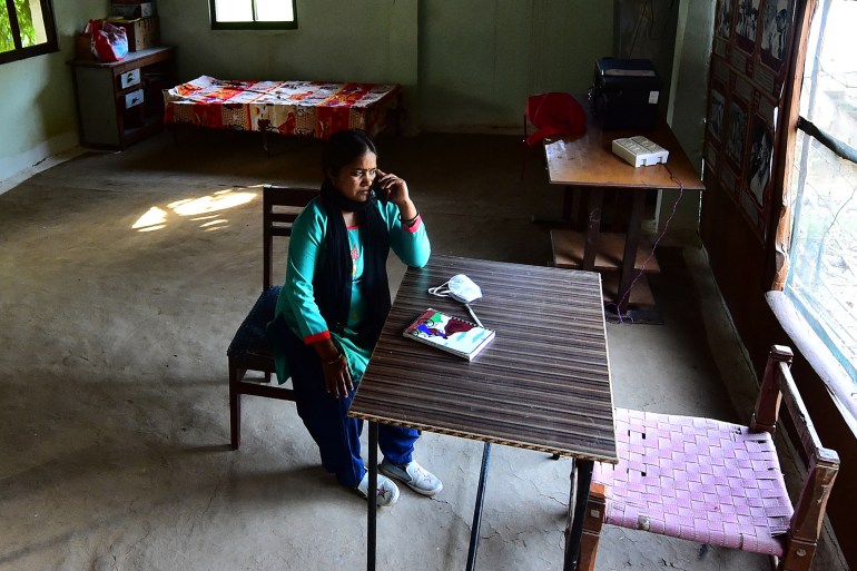 In this picture taken on March 11, 2022, Meera Devi, managing editor and reporter of "Khabar Lahariya" (Waves of News), spekas on her phone at her office in Banda district, Uttar Pradesh state. - An all-women team of smartphone-toting, low-caste reporters who chronicle India's hardscrabble heartland may give the cinema-mad country its first Oscar-winning film, after their own story became a critically lauded documentary. (Photo by SANJAY KANOJIA / AFP) / TO GO WITH India-social-media-film-oscar,FOCUS by Abhaya SRIVASTAVA