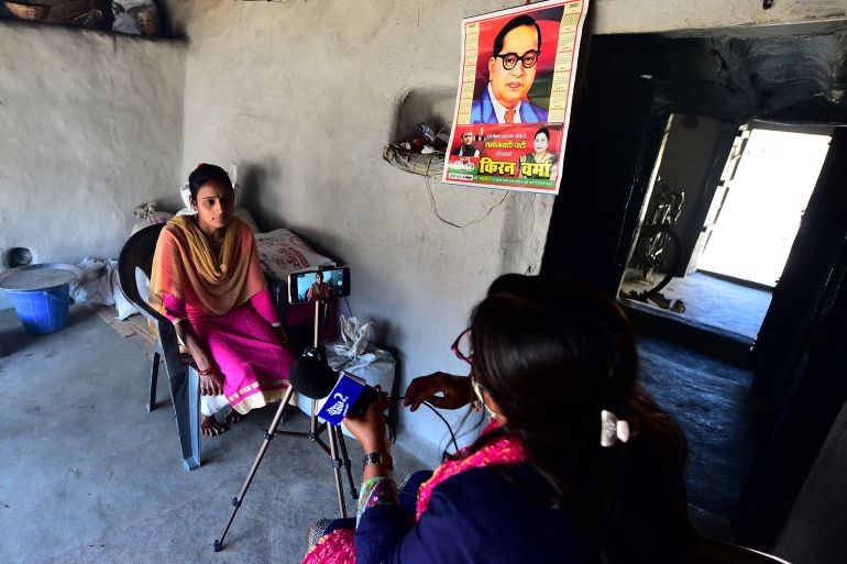 In this picture taken on March 11, 2022, Geeta Devi , senior journalist of Khabar Lahariya, interviews a woman who she says was abandoned by her husband, while reporting in Banda district, Uttar Pradesh state
