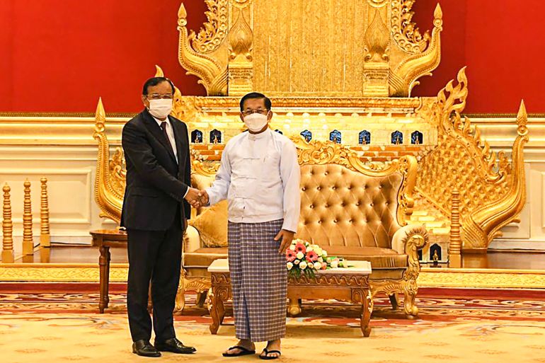 The ASEAN envoy in a western-style suit meets Myanmar coup leader Min Aung Hlaing, wearing a traditional outfit, in the capital Naypyidaw
