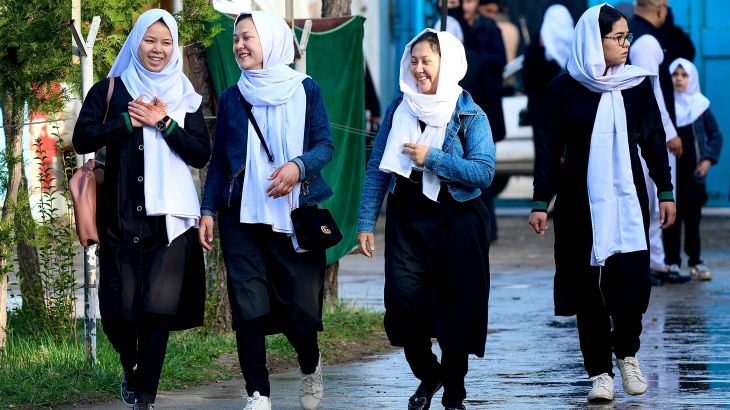 Girls arrive at their school in Kabul