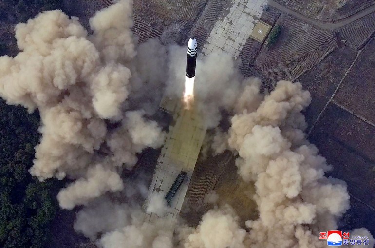 The ICBM seen launching into the air form above amid billowing clouds of smoke