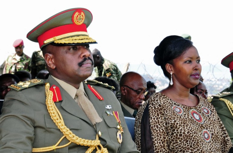 The son of Uganda's President Yoweri Museveni, Major General Muhoozi Kainerugaba (L) and his wife Charlotte Kutesa Kainerugaba (R) attend a ceremony in which Kainerugaba is promoted from Brigadier to Major General at the country's military headquarters in Kampala on May 25, 2016.