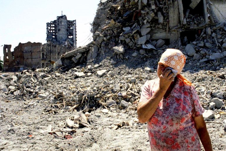An elderly Chechen woman wipes away tears as she stands near her house in Grozny on June 24 destroyed by shelling during the conflict between Chechen rebels and Russian governmental troops