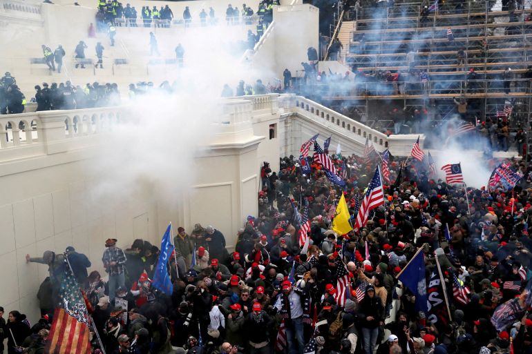 Police release tear gas into a crowd of pro-Trump protesters during clashes at a rally to contest the certification of the 2020 US presidential election in Washington, DC.