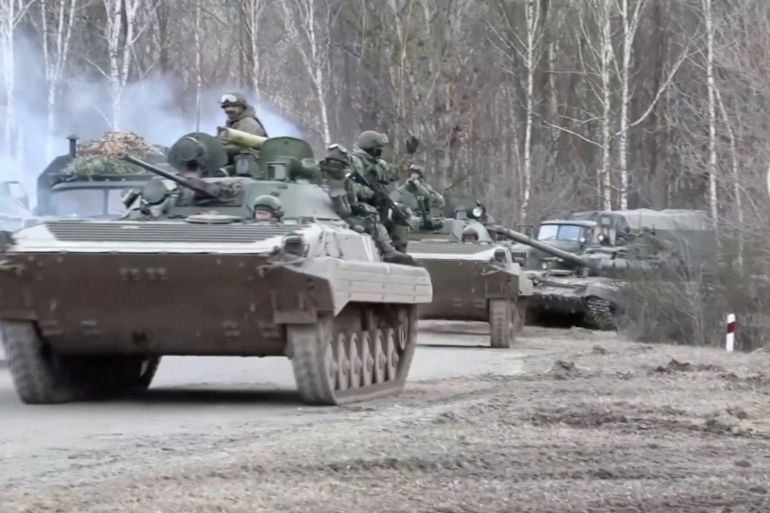 Russian tanks move along a road near Kyiv