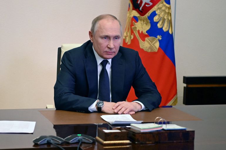 Russian President Vladimir Putin chairs a meeting with members of the Security Council via a video link at the Novo-Ogaryovo state residence outside Moscow