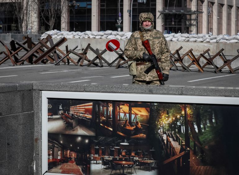 A member of the Ukrainian Territorial Defence Force is seen keeping watch in central Kyiv