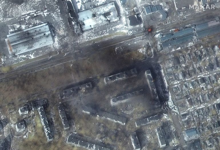A satellite image shows a multispectral close up view of apartment buildings and fires, in the western section of Mariupol, Ukraine 